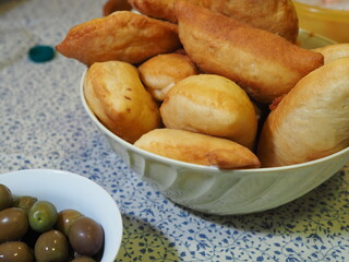 Dinner at home for a birthday party. Handmade fried panzerotti, a typical dish of southern Italian cuisine, served on a table.
