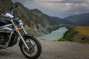 Motorcycle on the background of mountain river and rocks. Action camera is mounted on the motorbike...