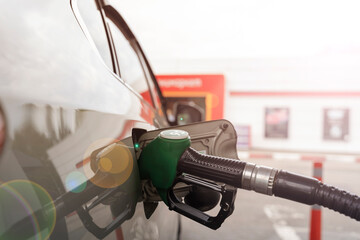 refueling gun in the gas tank, the concept of increasing fuel prices