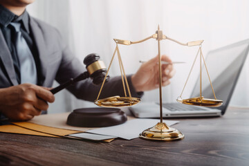 Business and lawyers discussing contract papers with brass scale on desk in office. Law, legal...
