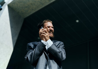business man in a suit talking on the phone outdoors business manager executive