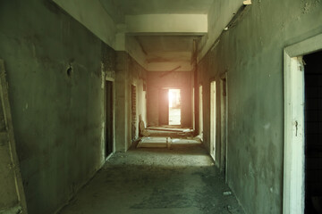 Fototapeta na wymiar Dark creepy empty corridor of abandoned building