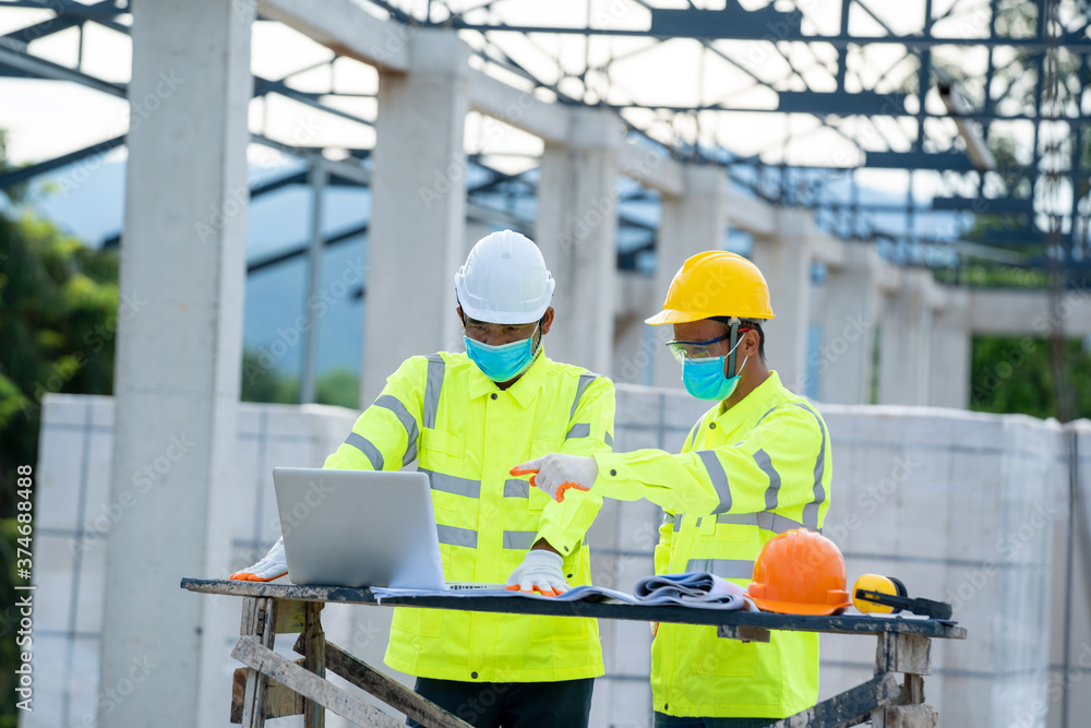 Aufkleber construction manager and engineer use laptop working about project in building construction site.