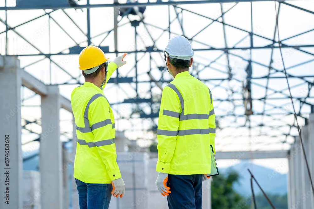Poster structural engineer and architect dressed in green work vests work in progress of construction proje