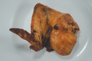 Tasty grilled chicken wings on a white dish