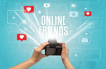 Close-up of a hand taking photos with ONLINE FRIENDS inscription, social media concept