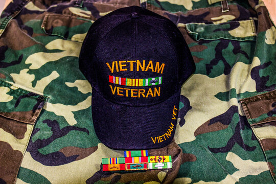 Vietnam Veteran Hat With Service Ribbons On Camouflage Uniform