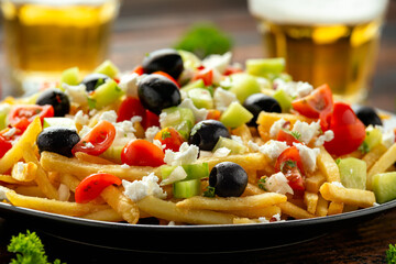 Loaded potato Vegan Fries with tomato, cucumber, olives and feta cheese