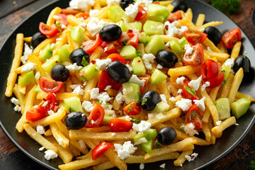 Loaded potato Vegan Fries with tomato, cucumber, olives and feta cheese