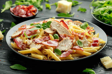 Chicken, bacon Penne pasta with parmesan cheese and basil. healthy food.