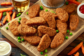 Vegetarian vegan southern style crispy nuggets served with sweet potato chips and beer