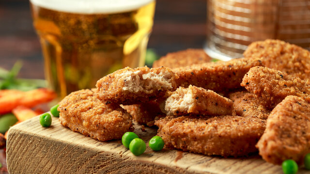 Vegetarian vegan southern style crispy nuggets served with sweet potato chips and beer