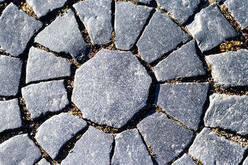 Paving slabs of gray stone laid out in a circle, background, texture