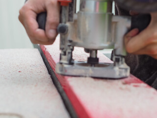 the man handles the product with a hand mill. woodwork.