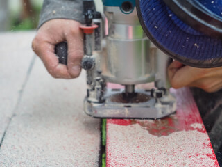 the man handles the product with a hand mill. woodwork.