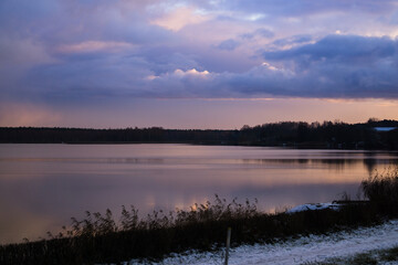 Fototapeta premium Beautiful landscape of thunderclouds over a quiet river.