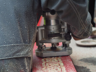 the man handles the product with a hand mill. woodwork.