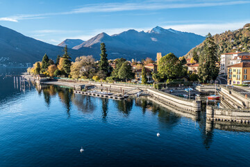 Fototapeta premium Aerial view of Maccagno with plants that are reflecting in the Lake Maggiore