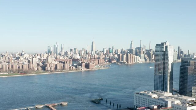 NYC Skyline with Empire State Building From Brooklyn side camera going down on a sunny day neutral CC