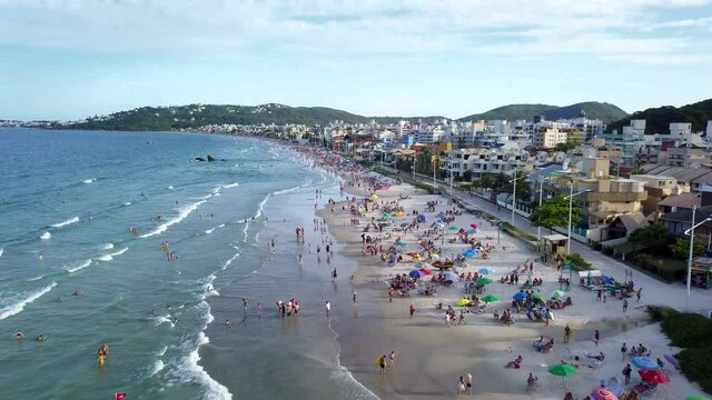 Aerial shot of tourists relaxing and enjoying Bombas beach on the south of Brazil