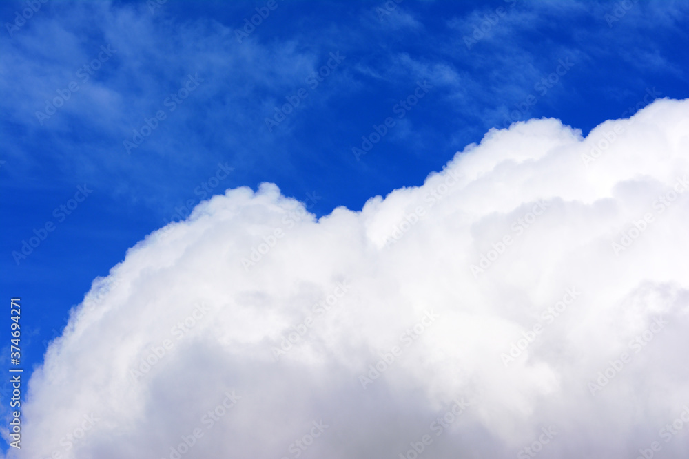 Wall mural Large cloud and a blue saturated sky