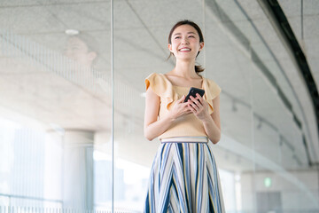 Woman at office using smartphone.