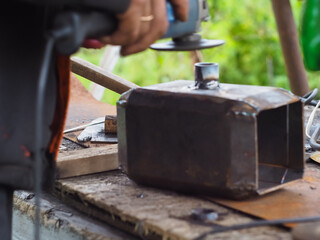 a man handles metal with an angle grinder. sparks from metal.