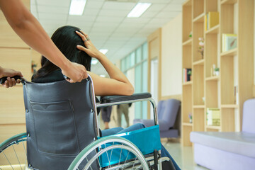 Woman  patient sitting on wheelchaira at modern hospital