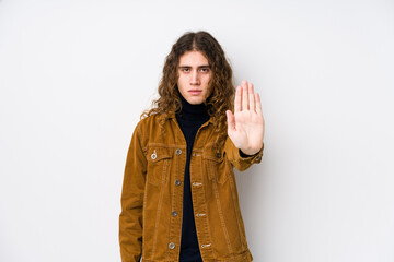 Long hair man posing isolated standing with outstretched hand showing stop sign, preventing you.