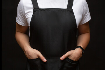 Black apron on a man closeup - obrazy, fototapety, plakaty