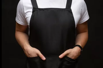 Fotobehang Black apron on a man closeup © Nadiia
