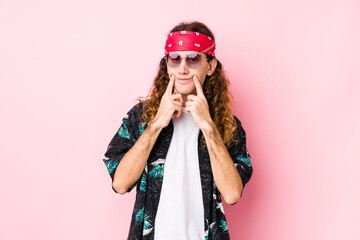 Young hippie caucasian man isolated doubting between two options.