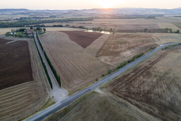 Aerial view of dawn in the valley of the edge, the sun just arose, the countryside in Tuscany