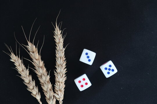 Spikelets And Dice Symbolize The Unpredictability Of The Grain Harvest