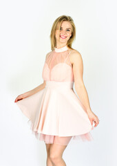 Naklejka premium Clothing store. looking trendy and stylish. fashionable look of sexy woman. having perfect hairstyle. female beauty and fashion. beauty smile. sexy blond wear pink dress. ready for formal party