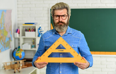 Back to school. Man teacher mentoring school projects. Science modern school. Math subject. Study...