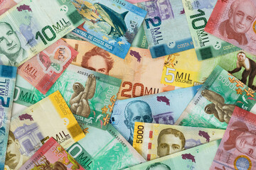  Costa Rica money. All denominations, paper banknotes, scattered on the table