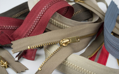 Pile zippers on a white background © OttoPles