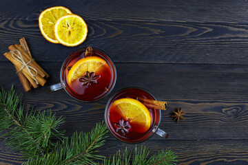 Mulled wine with slice of orange, cinnamon sticks and anise stars, winter drink
