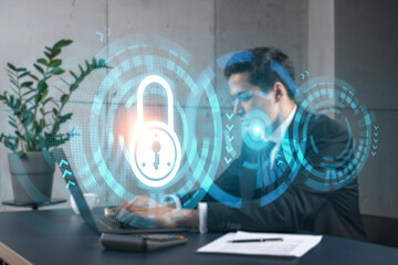 Businessman in office working with laptop, develop data protection system to diminish business risks, typing computer. Double exposure.