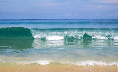 Flying butterfly over a high wave at Karon Beach in Phuket, Thailand