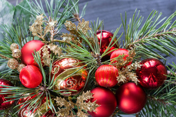 Christmas and new year festive background. Red balls on fpine branches, decorated floristic Christmas composition.