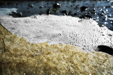 Stack of foam on the shore of Lake accumulated torrential waves