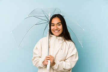 Young asian woman holding a umbrella laughing and having fun.