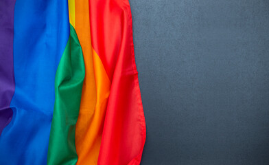 Rainbow LGBT flag on chalkboard, black board with space for text, gay flag as background, concept picture
