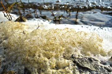 Stack of foam on the shore of Lake accumulated torrential waves