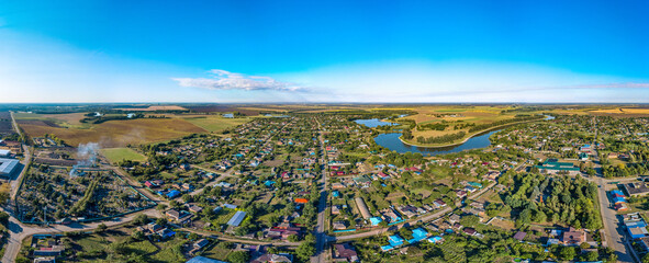 aerial panorama of the village of Sergievskaya (South of Russia) and the bend of the Kirpili river on a sunny summer day