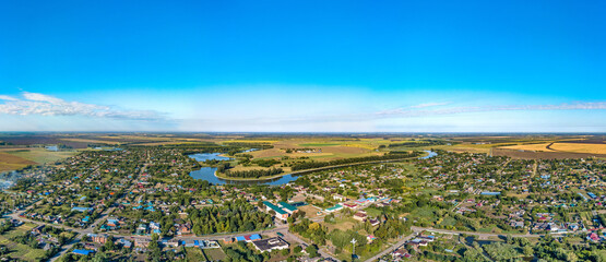 aerial panorama of the village of Sergievskaya (South of Russia) and the bend of the Kirpili river on a sunny summer day