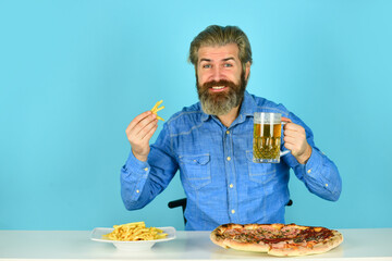 Good appetite. Still hungry. Beer and food. Dinner at pub. Hungry man going to eat pizza french fries and drink beer. Pizzeria restaurant. Cheerful man bearded hipster eat pizza. Pizza party concept