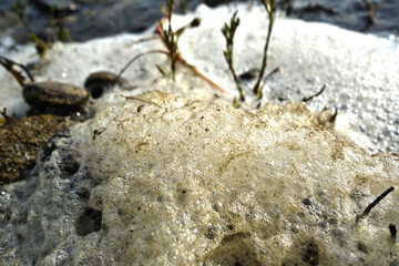 Stack of foam on the shore of Lake accumulated torrential waves